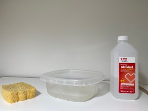 Sponge, plastic container and a bottle of Isopropryl alcohol